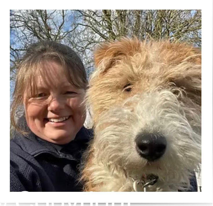 Claire with two happy dogs on a walk